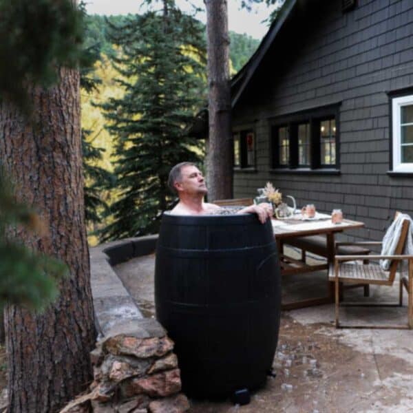 man doing plunge in ice barrel 400 outside