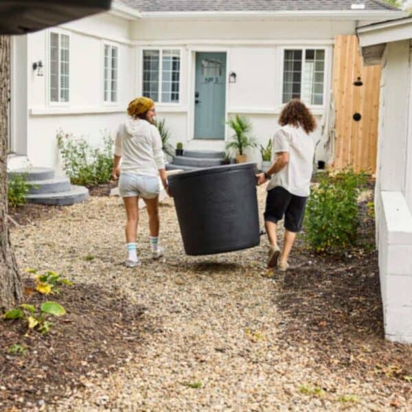 man and woman carrying ice barrell 300 using the handles