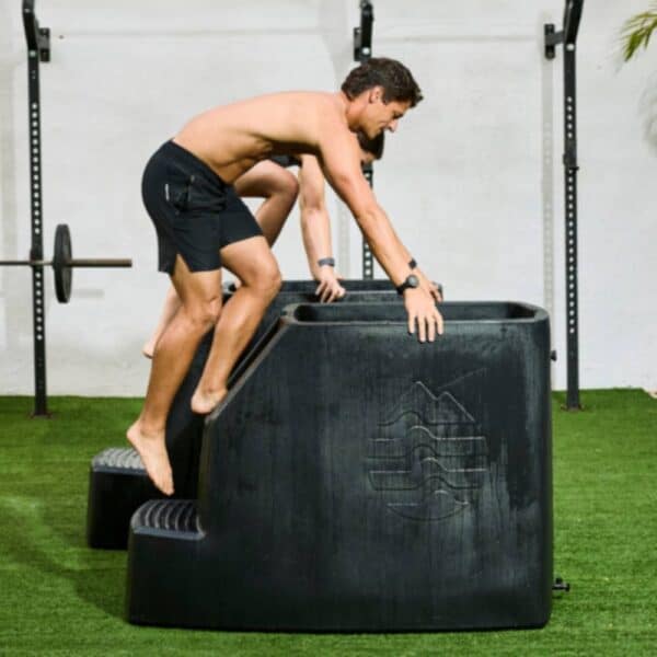 Man doing obstacle course training outdoors.