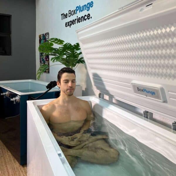 Man experiencing ice bath in BoxPlunge tank.